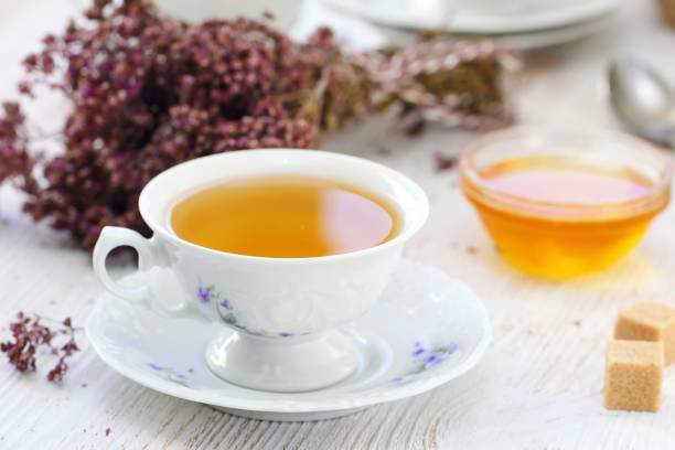 istock Cup of herbal tea and flowers 1007258382