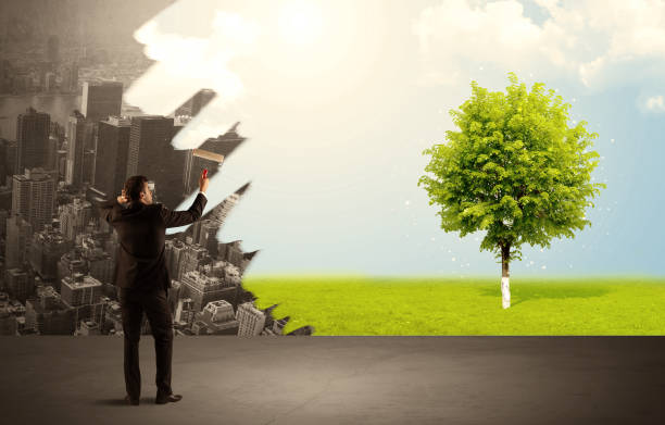 istock Salesman painting tree instead of city 1007259028