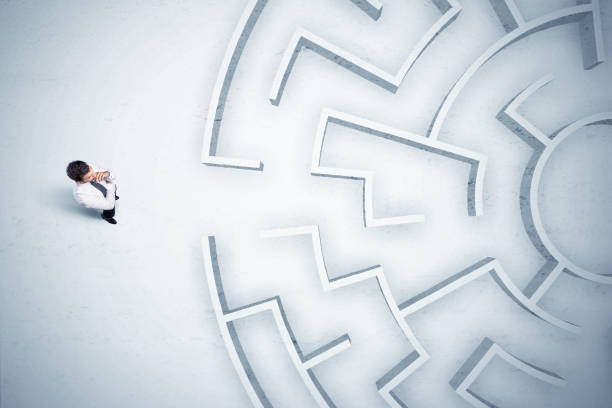 istock Business man looking at circular maze with nowhere to go 1007261918