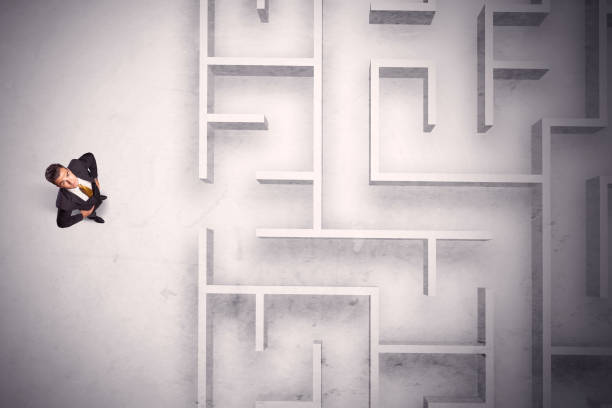 istock Confused businessman standing at a maze wall 1007261964