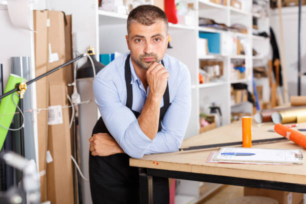istock man designer and print operator with paper print at print manufacturing 1007269720