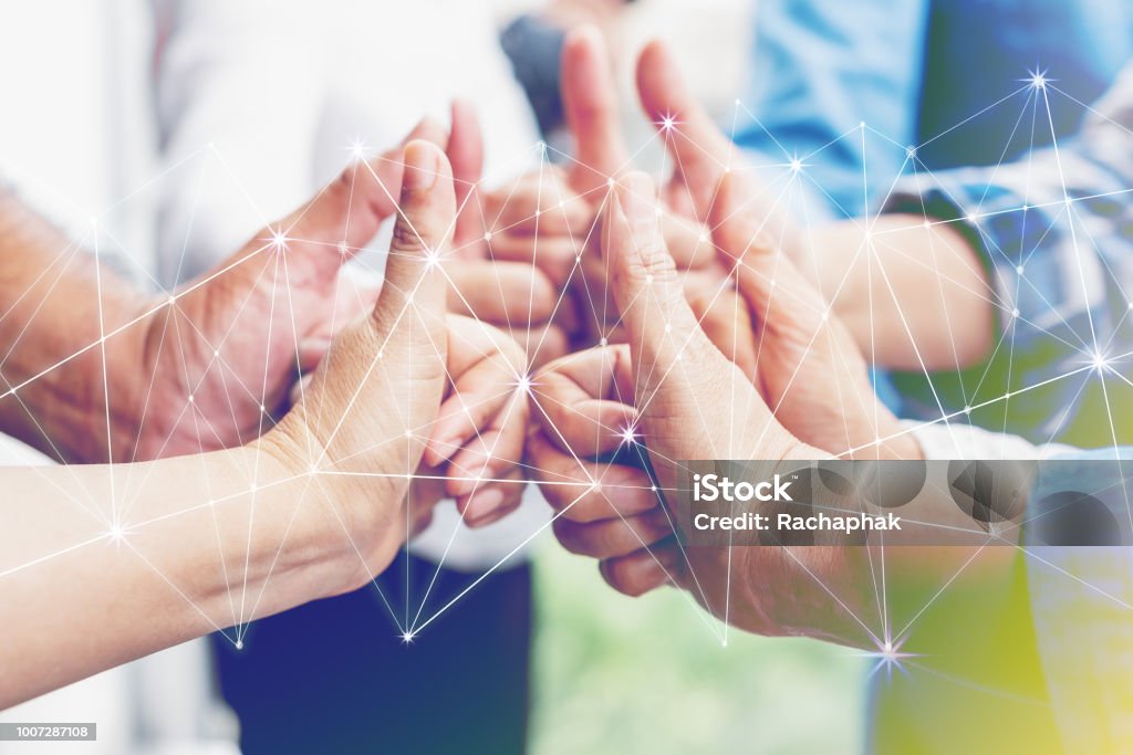 Business partners team achievement concept. Multi-ethnic diverse group of colleagues join hands together. Creative teamwork,business agreement. Important of teamwork. Morality Stock Photo