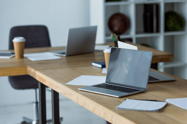 istock laptops and coffee in paper cups on table in start up office 1007293998