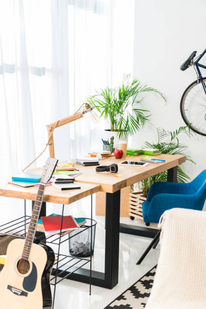 istock working table and acoustic guitar at home 1007300332