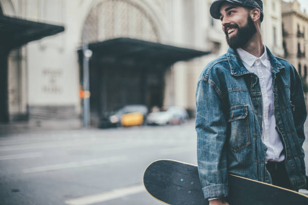 istock Handsome young man carrying skateboard 1007304050