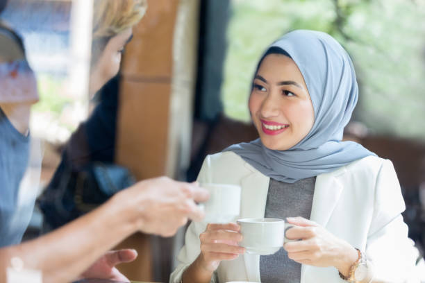 istock Young Malaysian woman enjoys coffee date 1007304298