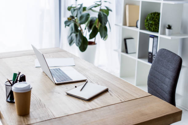 istock laptop and coffee in paper cup on table in business workspace 1007305120