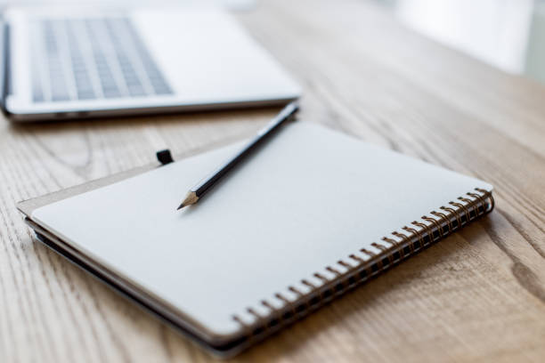 istock laptop, notebook and pencil on table in business office 1007305130