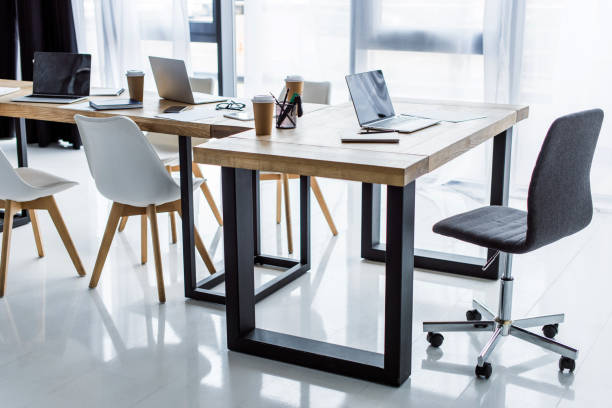 istock interior of business office with laptops on tables 1007305136