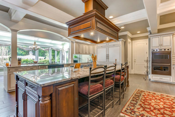 istock Stunning kitchen room design with large bar style island. 1007310518
