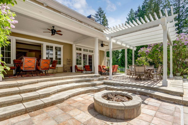 Lovely outdoor deck patio space with white dining pergola. Lovely outdoor deck patio space with white pergola, fire pit in the backyard of a luxury house. porch stock pictures, royalty-free photos & images