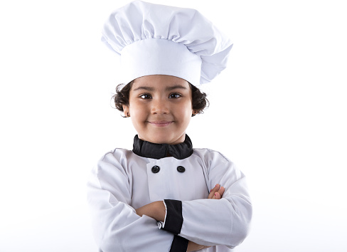 Portrait of cute little girl dressed up as chef