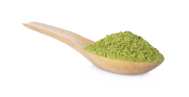 istock green tea powder with wooden spoon isolated on white 1007321794