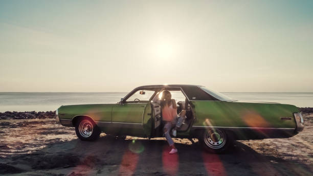 istock Woman with retro car 1007325316