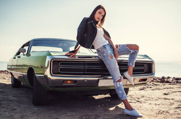istock Woman with retro car 1007325434