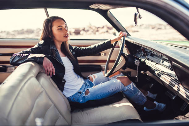 istock Woman with retro car 1007325526