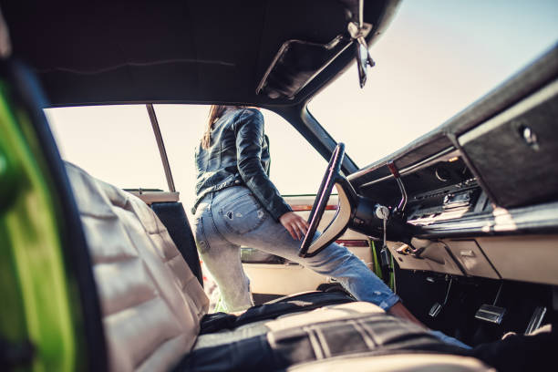 istock Woman with retro car 1007325558