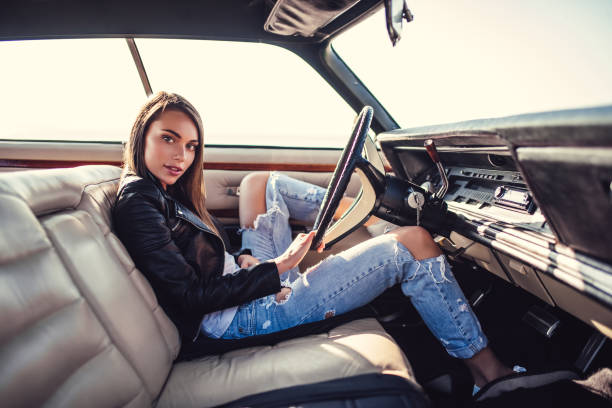 istock Woman with retro car 1007325574
