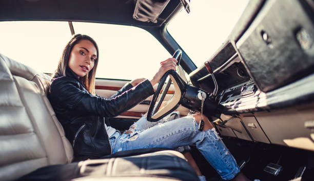 istock Woman with retro car 1007325630