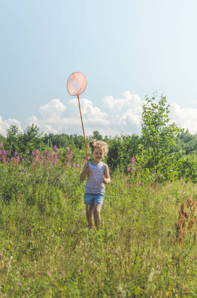 istock child with a net catches a butterfly 1007326482
