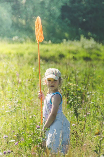 istock child with a net catches a butterfly 1007326630