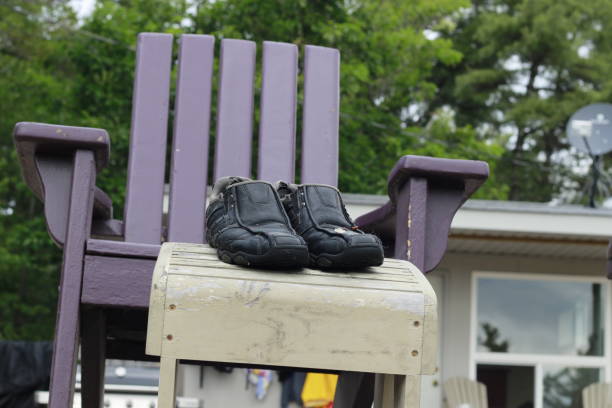 istock mans dress shoes overlooking a cottage themed background. Representing anthropomorphic object, business man escaping the reality of work 1007329768