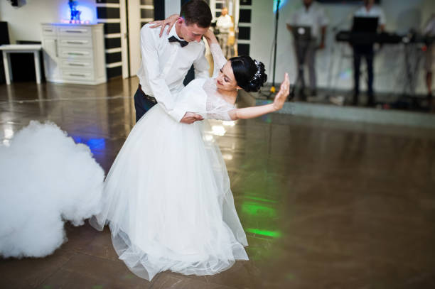 istock Romantic newly married couple performing their first dance in the restaurant. 1007342242