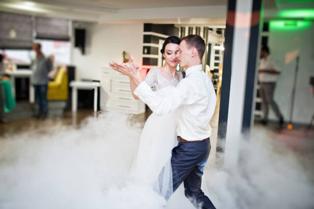 istock Romantic newly married couple performing their first dance in the restaurant. 1007342302