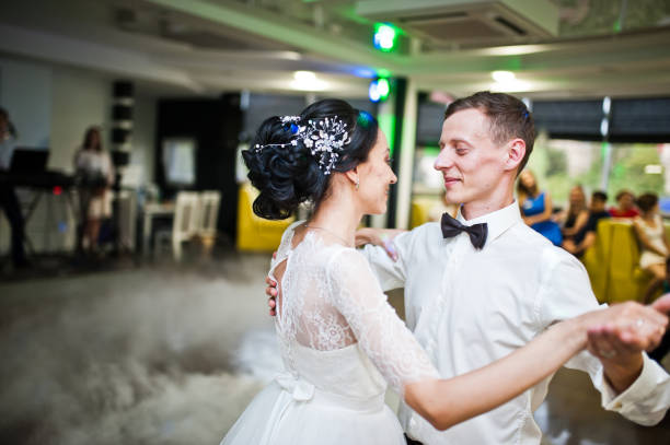 istock Romantic newly married couple performing their first dance in the restaurant. 1007342388