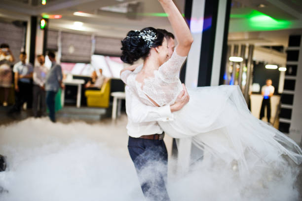 istock Romantic newly married couple performing their first dance in the restaurant. 1007342422
