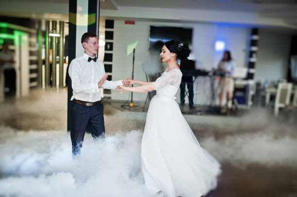 istock Romantic newly married couple performing their first dance in the restaurant. 1007342462