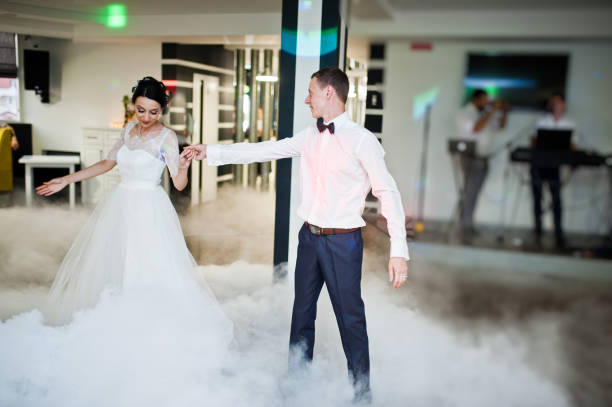 istock Romantic newly married couple performing their first dance in the restaurant. 1007342476