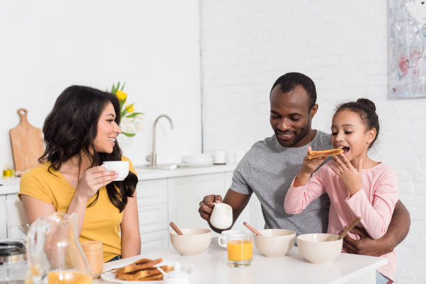 istock happy young family having healthy breakfast on kitchen together 1007345652