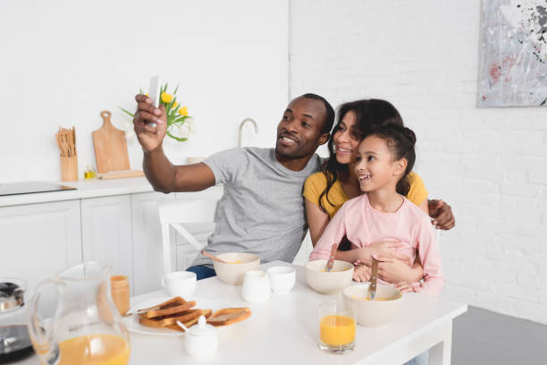 istock happy young family taking selfie on kitchen while having breakfast 1007345684