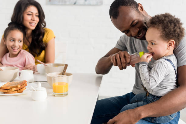 istock beautiful young family having breakfast together 1007345724
