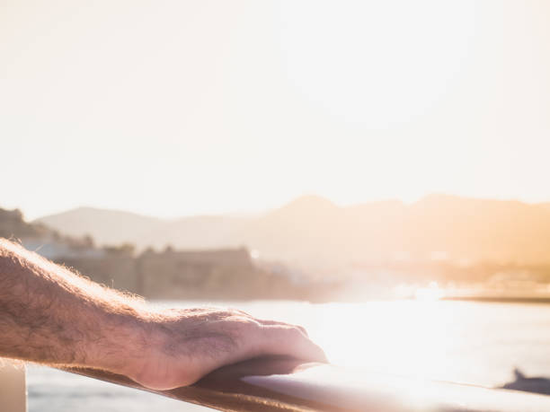 istock Men's hands on the railing of a cruise ship 1007363226