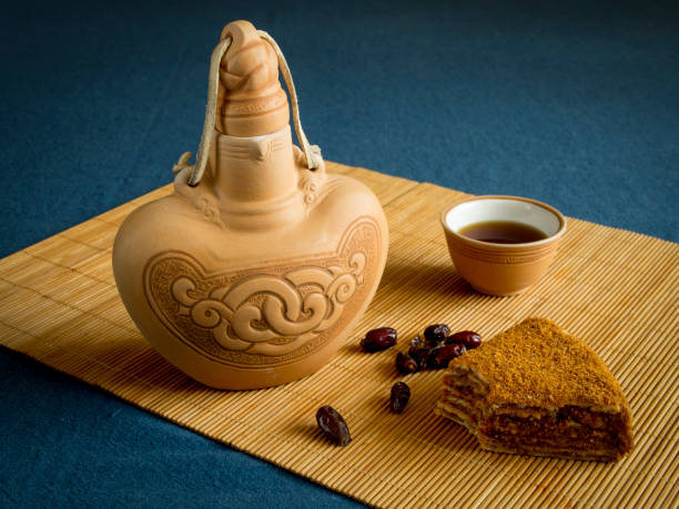 istock Ceramic bottle, cup of tea, piece of cake 1007363916