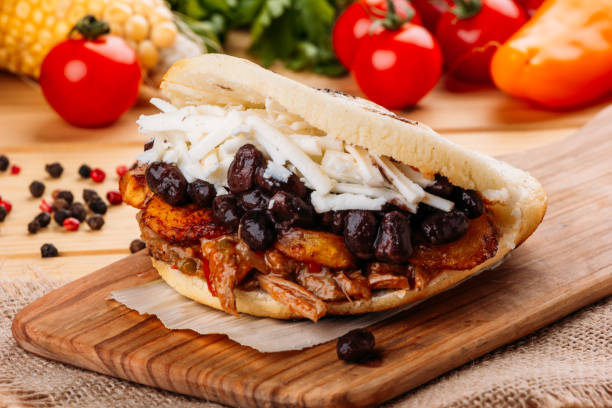 The typical Venezuelan Arepa called Pabellon, which has seasoned minced meat, fried plantain, black beans and white cheese stock photo