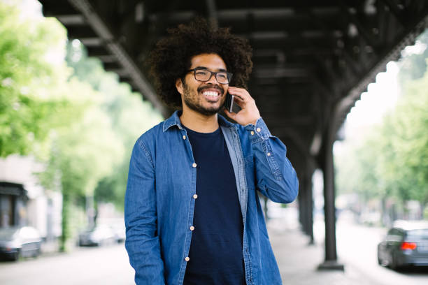 istock Happy young african man talking on phone outdoors 1007370418