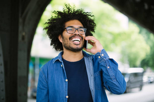 istock Cheerful man talking on cell phone outdoors 1007370550