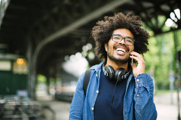 African man making a phone call outdoors on street