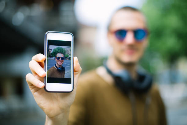 istock Young man showing his selfie to camera 1007370934