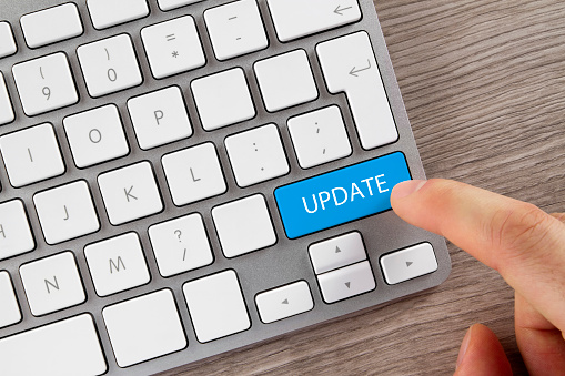 Index finger is pushing 'Update' button on computer keyboard