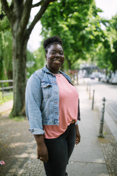 istock Smiling woman standing on sidewalk 1007381434