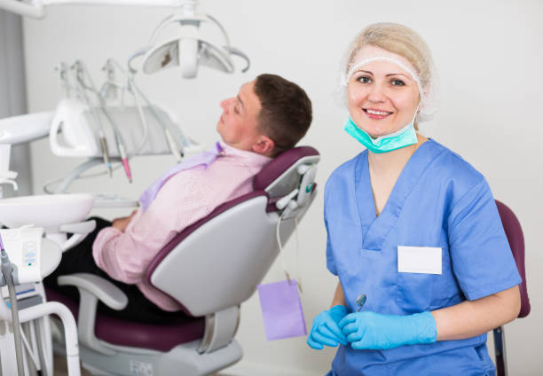 istock Female stomatologist with patient 1007387666