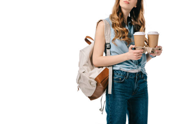 istock cropped image of student holding coffee in paper cups isolated on white 1007387974