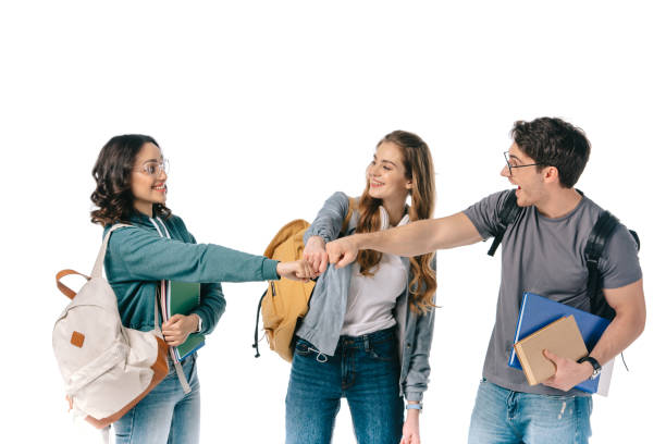 happy multicultural students making fist bump isolated on white