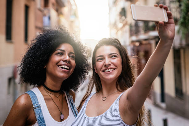 Beautiful women taking a self portrait in the Street. Beautiful women taking a self portrait in the Street. Youth concept. selfie madrid photos stock pictures, royalty-free photos & images