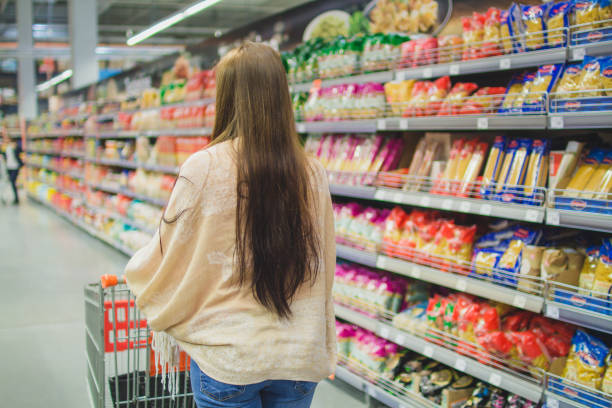 istock Women with cart shopping in supermarket 1007412708