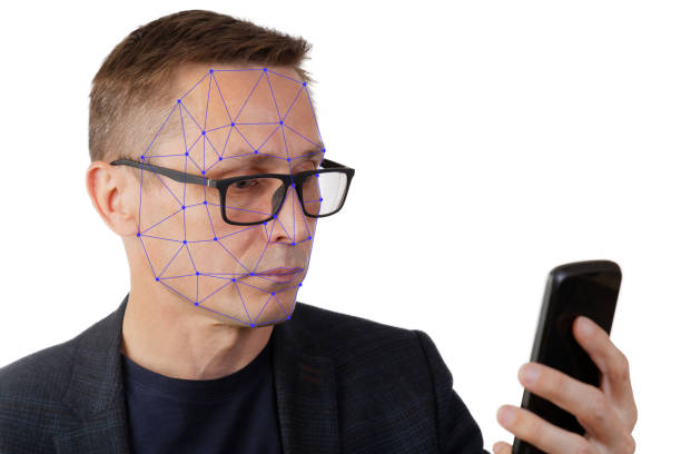 istock Portrait of man with smartphone using face ID recognition system. 1007419004